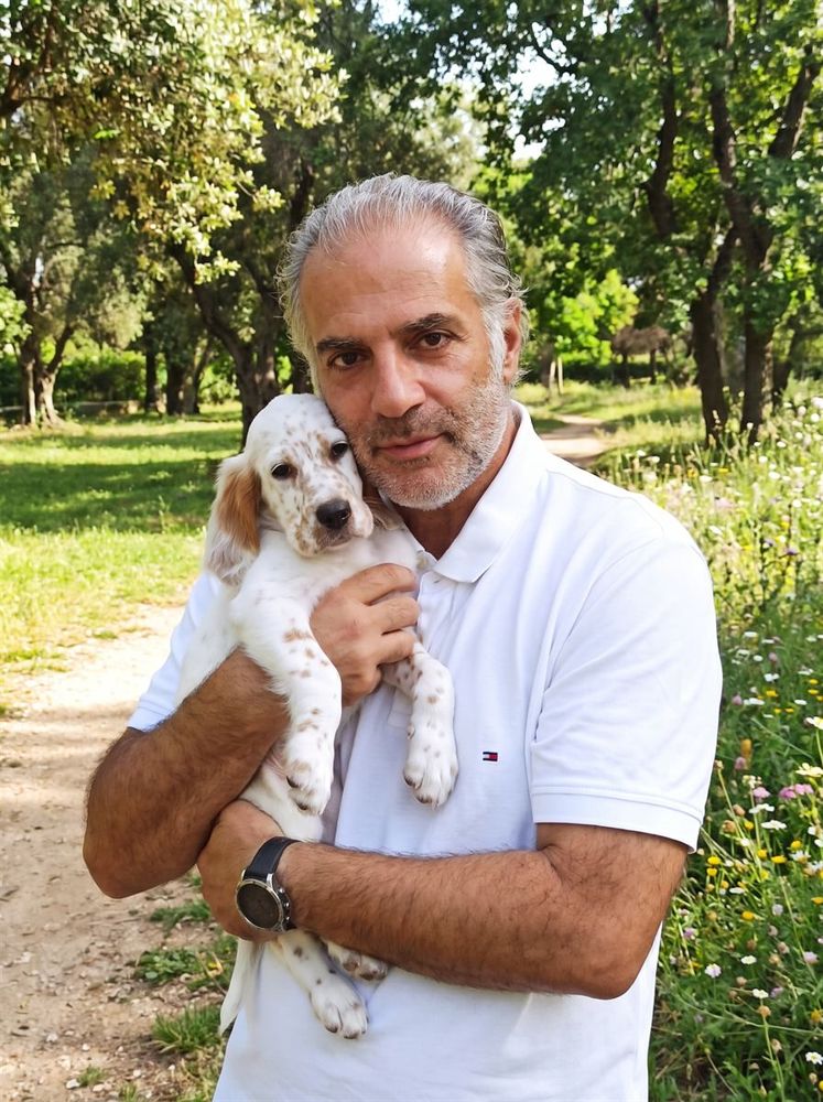 Mike Andreou holding a young English Setter